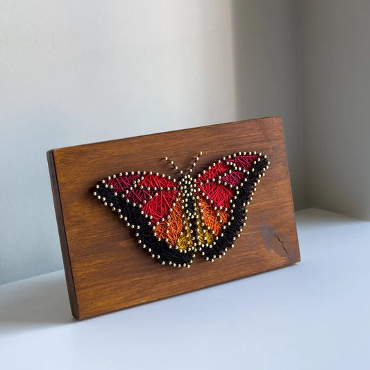 Butterfly string art kit with materials and tools for adult crafters.