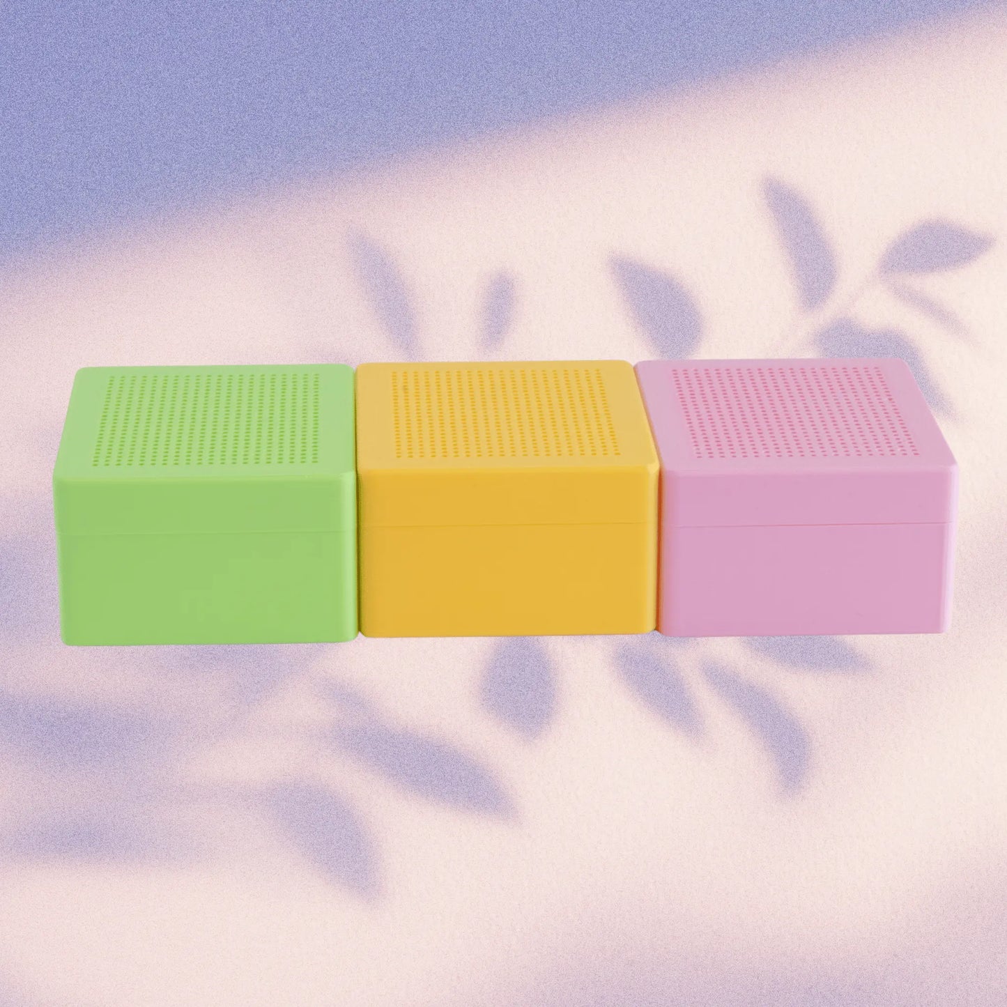 Set of three stitchable cross stitch boxes in green, yellow, and pink with blank grid lids, shown side by side