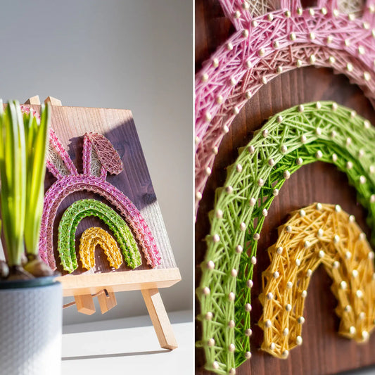 Easter Bunny Rainbow string art project displayed on a mini wooden easel near a potted plant, glowing in sunlight.