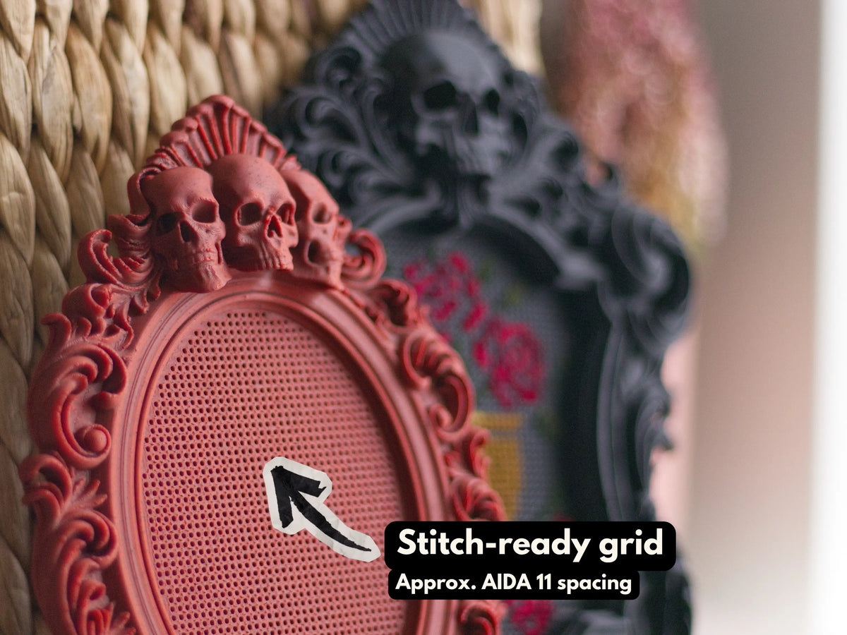 Close-up of the stitch-ready grid on a red skull frame, spaced close to Aida 11