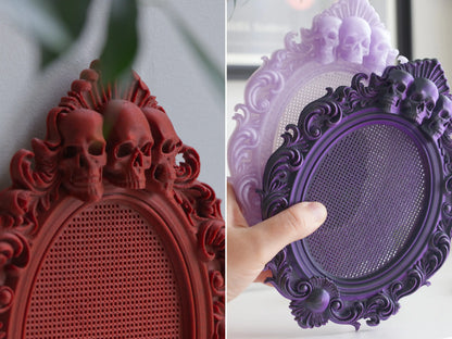 Detail of the skull crest on a red frame and a purple frame held in hand