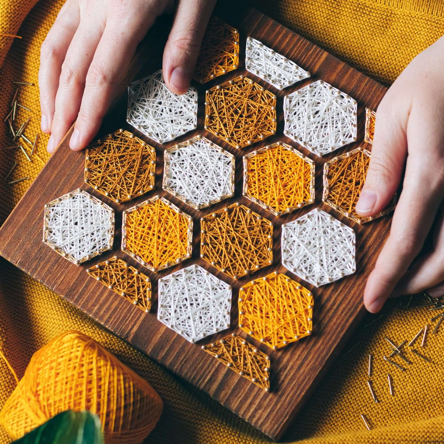 bee honeycombs string art sign on a wooden board made gold color nails and warm tone strings 