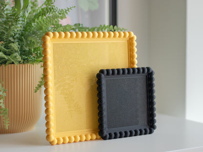 3D printed bubble cross stitch frame with a bobbin-style beaded border