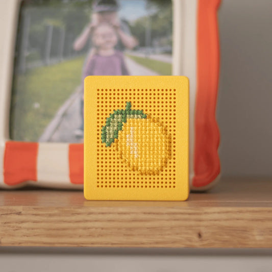 Yellow stitchable cross stitch box with finished lemon embroidery, shown as an example of stitching on a rigid embroidery box lid