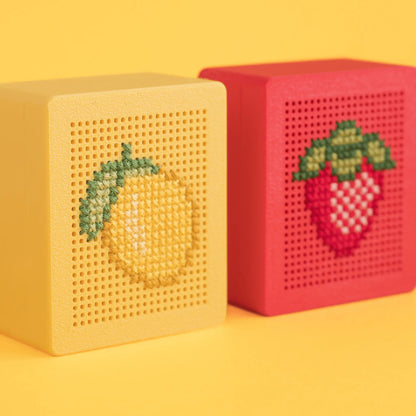 Yellow and red stitchable cross stitch boxes shown side by side, finished with lemon and strawberry embroidery designs