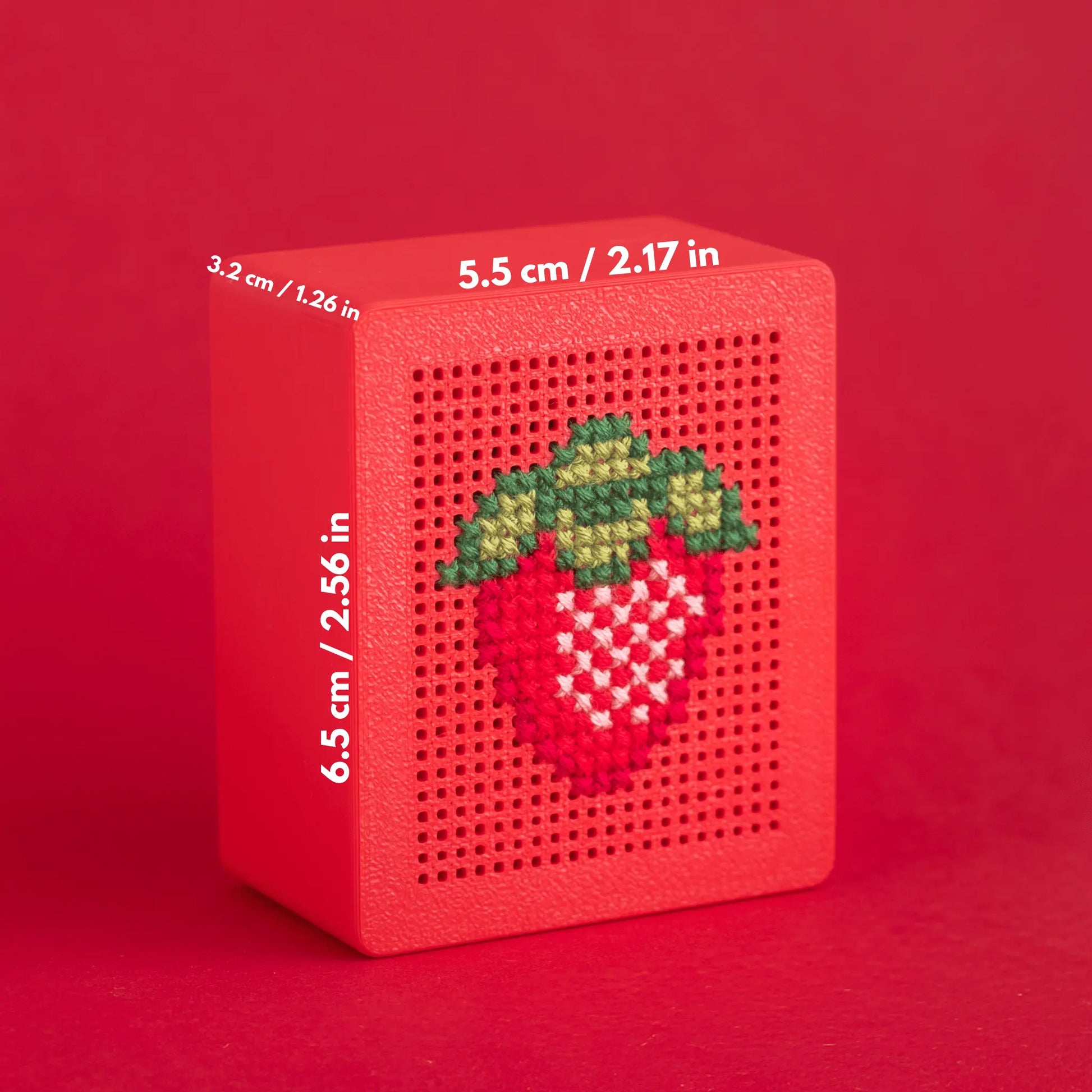 Red stitchable embroidery box showing box dimensions and a strawberry cross stitch example on a perforated lid, illustrating size and stitch grid of the cross stitch box base.