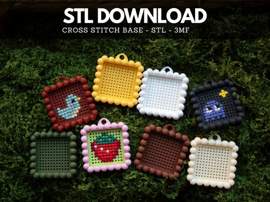 Eight 3D printed cross stitch keychain charms with bubble edges on green moss, stitched with a blue bird, a strawberry and a purple ghost, under an STL download banner.