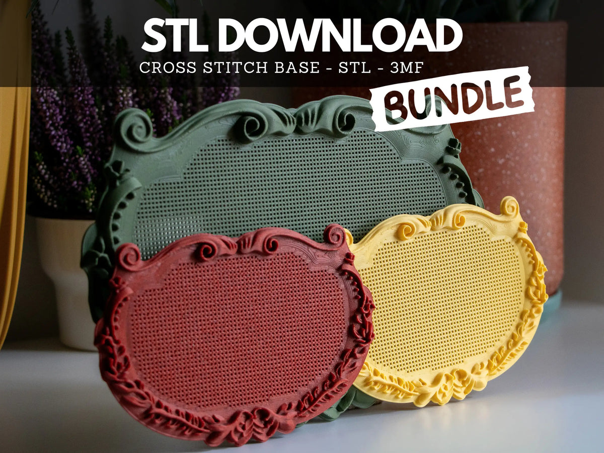 A large sage green and two small red and yellow ornate plaque cross stitch frames, 3D printed from the STL bundle, showing blank perforated stitching grids and scrollwork borders beside purple heather.