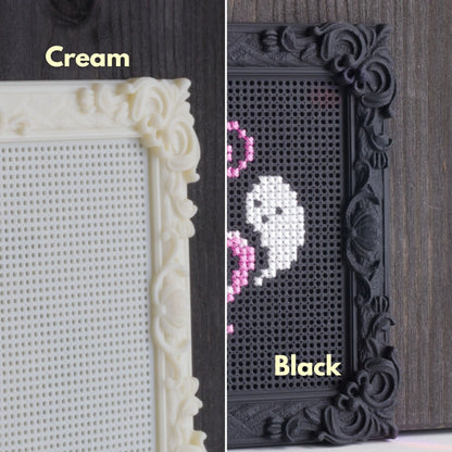 Close-up comparison of cream and black decorative stitchable embroidery frames showing perforated cross stitch surface and ornate frame details.