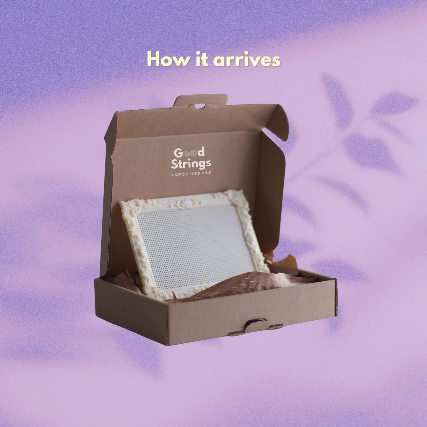 Packaging presentation showing a cream stitchable embroidery frame inside a GoodStrings shipping box.