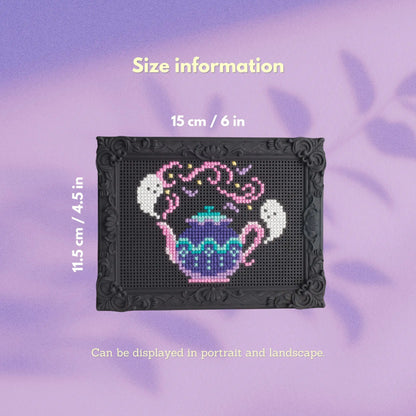 Decorative stitchable cross stitch frame with finished teapot embroidery showing frame size of 15 cm by 11.5 cm.