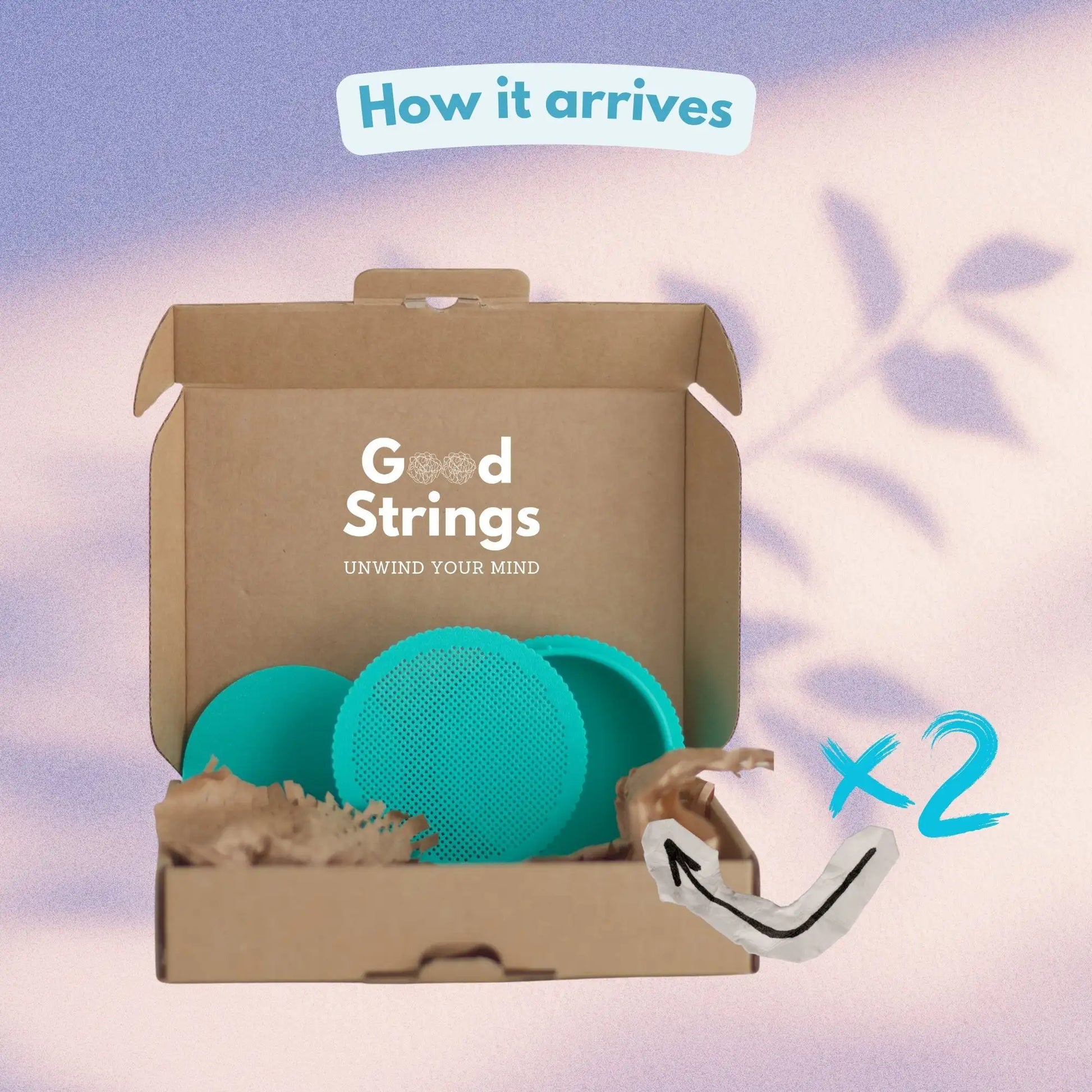 How the set of 2 round cross stitch boxes arrives — 2 teal stitchable boxes with perforated lids in branded GoodStrings cardboard packaging with recycled paper fill
