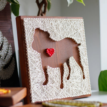 Completed dog silhouette with heart string art design on a wooden board, crafted using GoodStrings' beginner-friendly string art pattern. Features a white thread outline of a dog with a heart detail, perfect for DIY home decor.