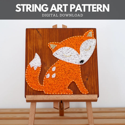 Completed cute fox string art design displayed on a wooden easel, made using GoodStrings string art pattern. Features an orange fox with white details, perfect for adding a playful touch to home decor.