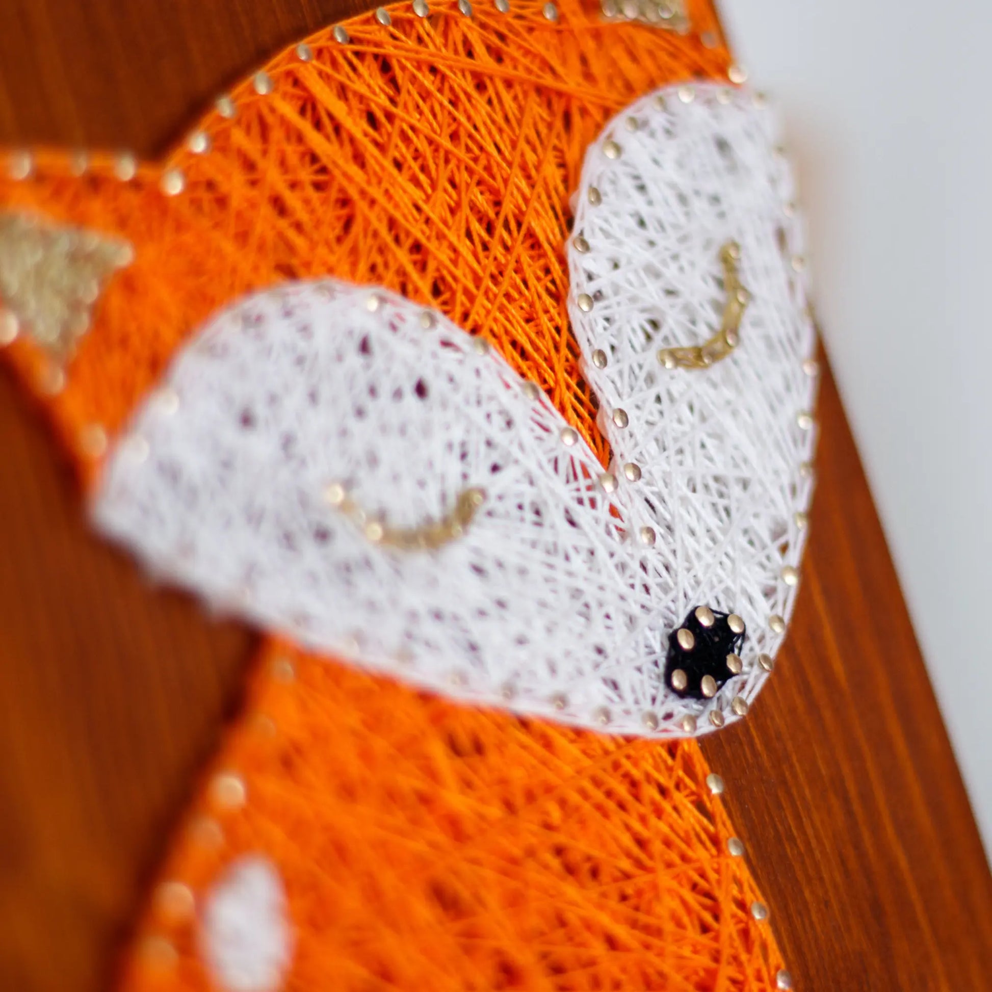 Close-up of the fox string art pattern focusing on the detailed threadwork around the fox's face and closed eyes, highlighting its intricate design.