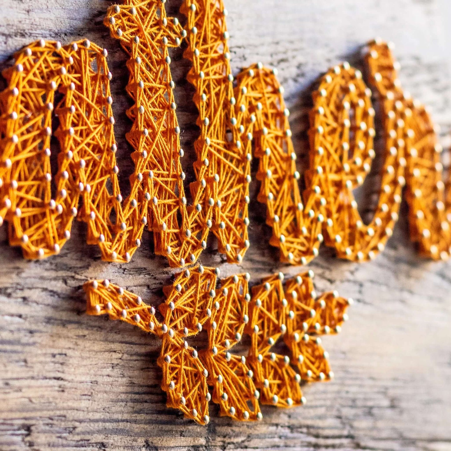 Close-up of the gather string art pattern, highlighting the texture and depth of the yellow string against the rustic wood. Ideal for autumn decor and a fun DIY craft project.