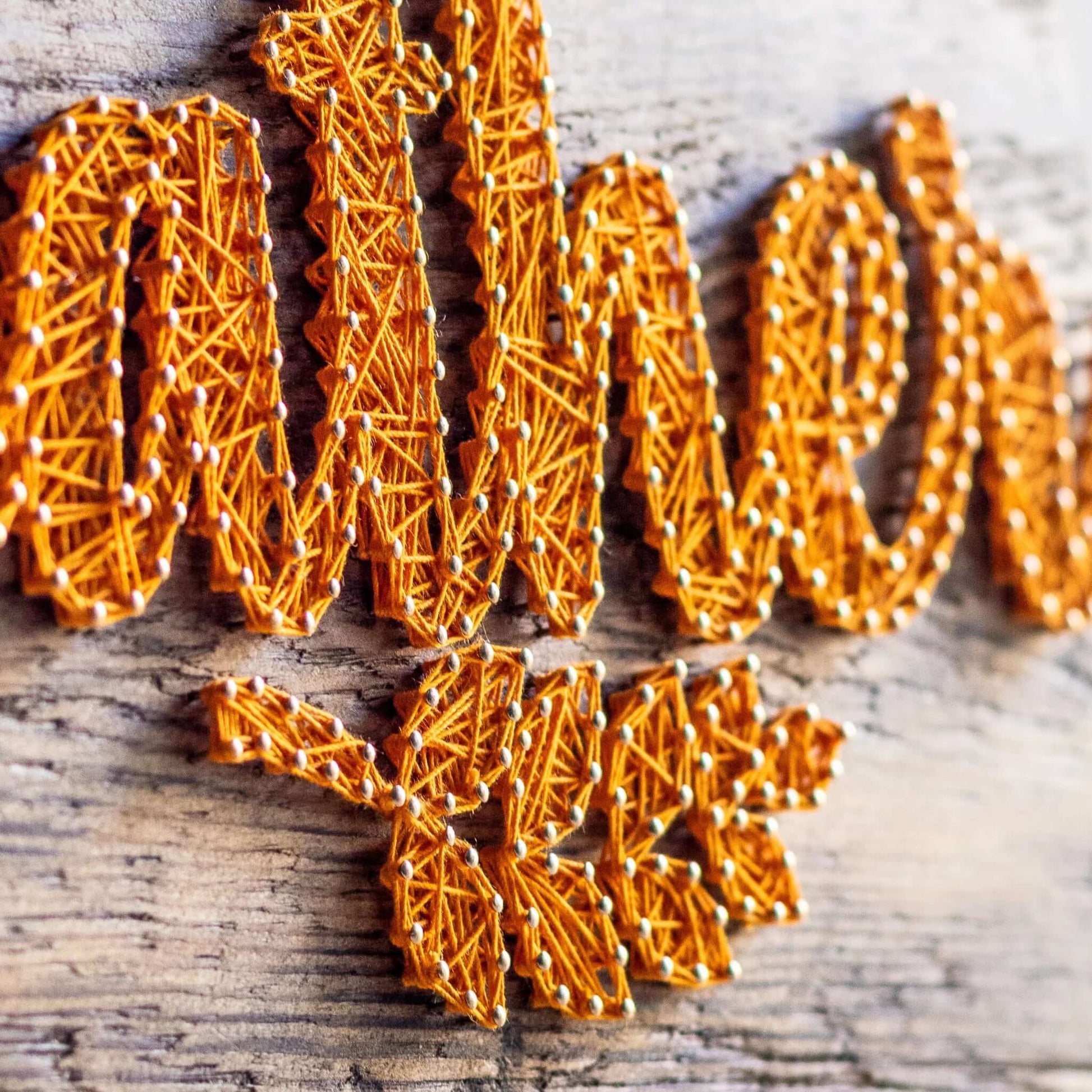 Close-up of the gather string art pattern, highlighting the texture and depth of the yellow string against the rustic wood. Ideal for autumn decor and a fun DIY craft project.