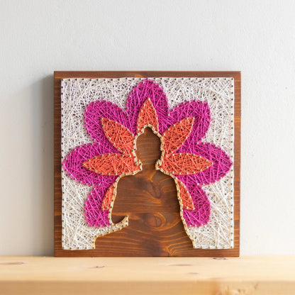 DIY string art kit featuring a Buddha silhouette surrounded by a colorful flower pattern on a wooden board by GoodStrings