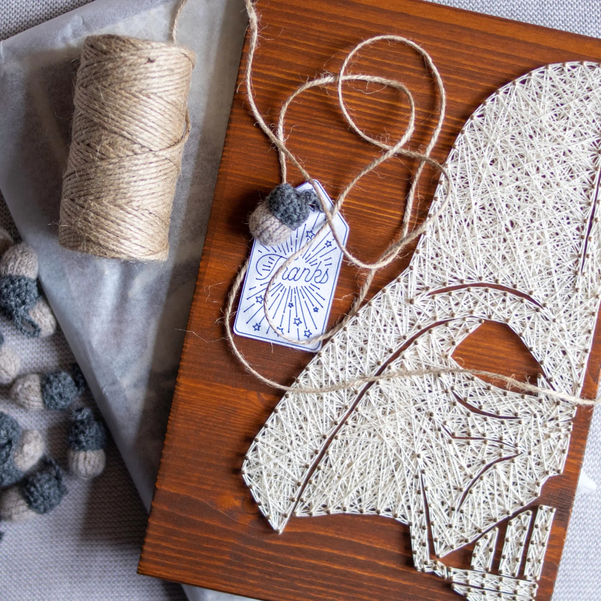 DIY string art kit featuring a silhouette of Star Wars Darth Vader outlined with white thread on a rustic wooden board by GoodStrings - top 