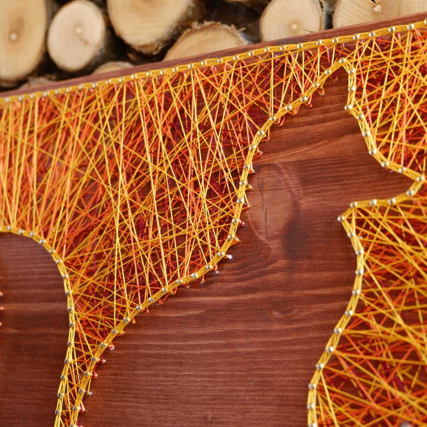 Orange and yellow fox string art on a wooden board from Goodstrings DIY kits for adults.