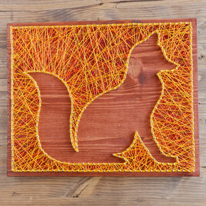 Orange and yellow fox string art on a wooden board from Goodstrings DIY kits for adults.