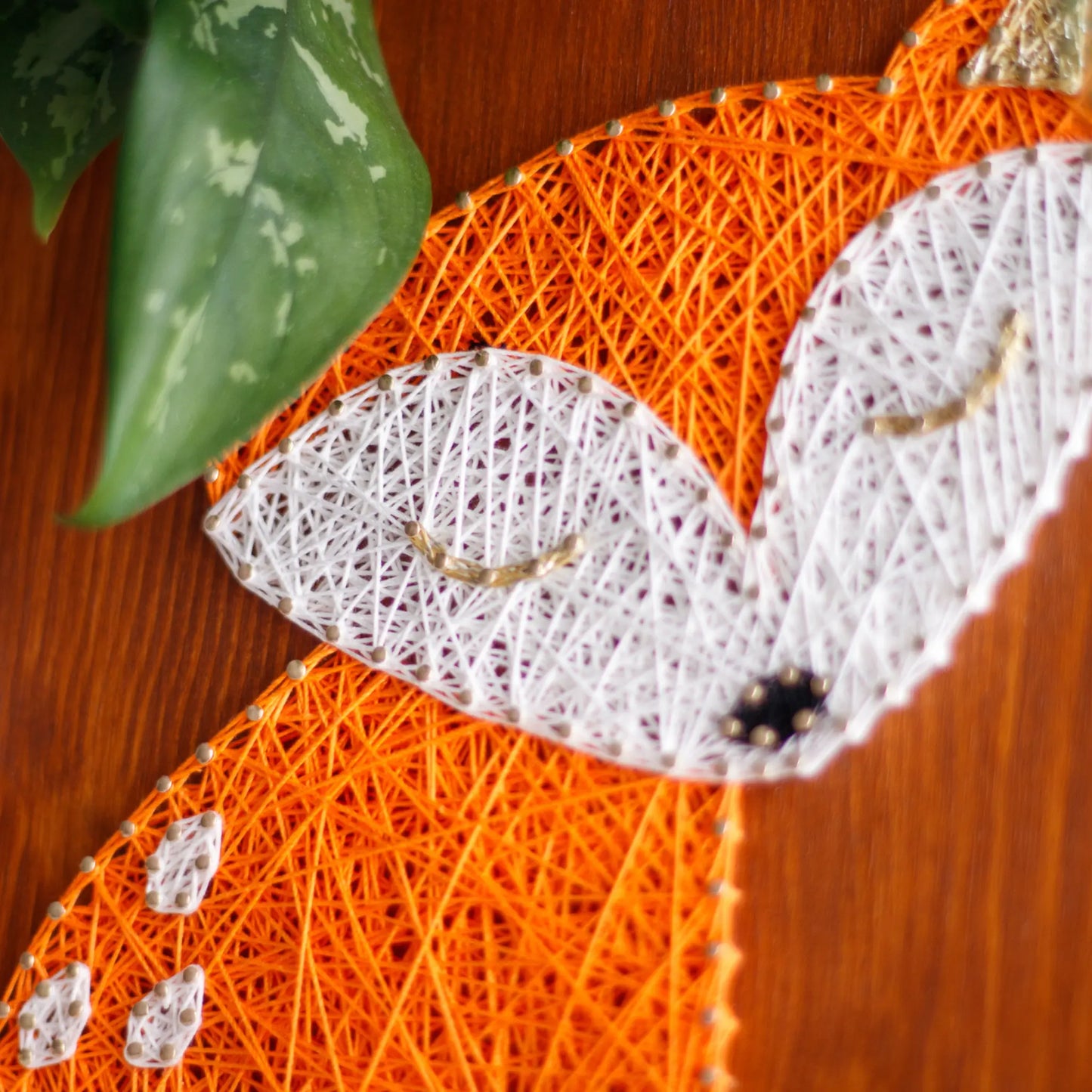 DIY string art kit featuring a cute fox silhouette with orange and white threads on a rustic wooden board by GoodStrings - details