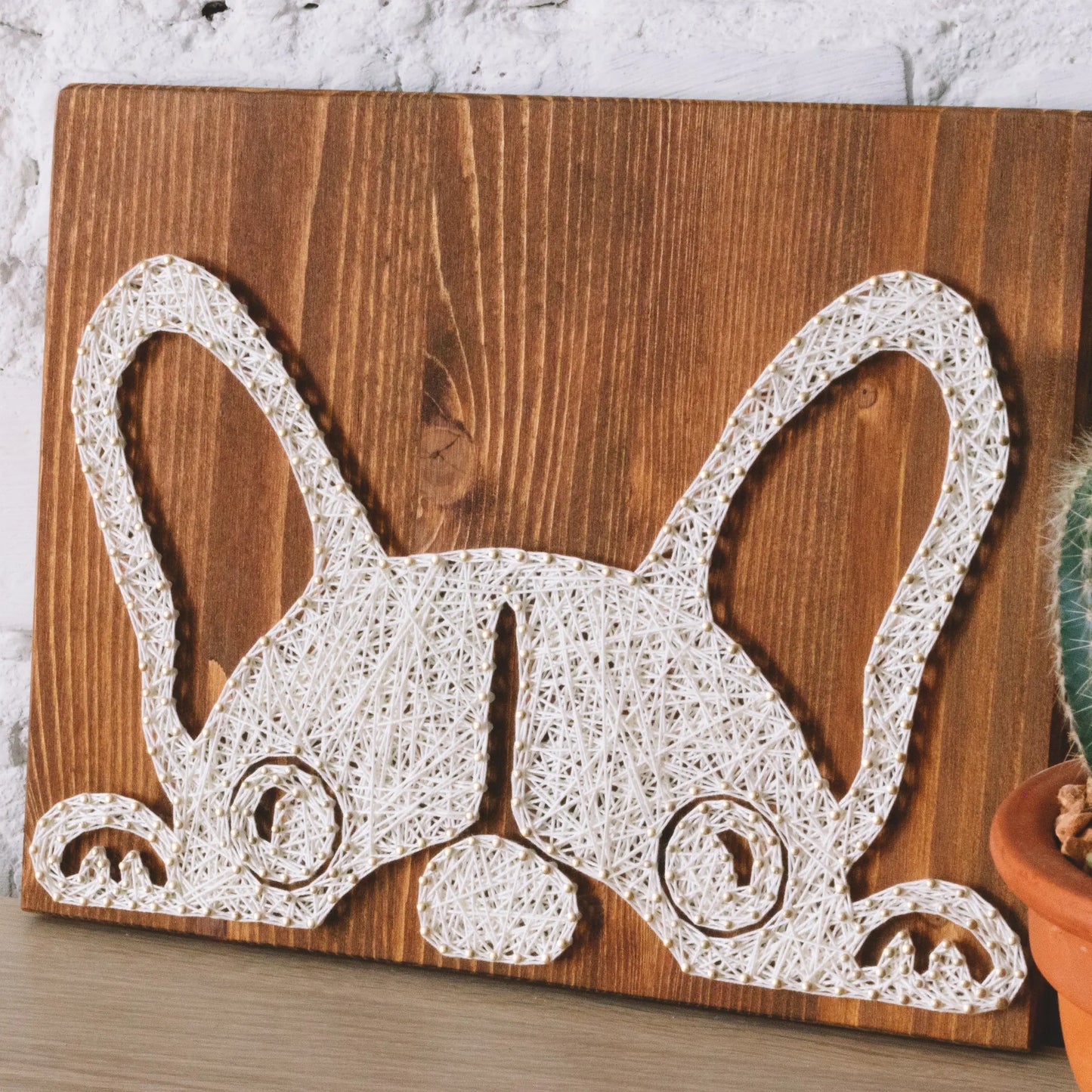 DIY string art kit featuring a cute French Bulldog silhouette outlined with ivory thread on a rustic wooden board by GoodStrings - slide view