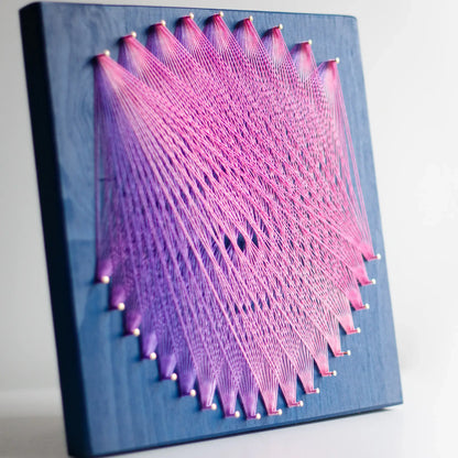 Geometric string art with pink and purplethreads on blue base, perfect craft kit for adults, showcasing intricate design - purple and pink