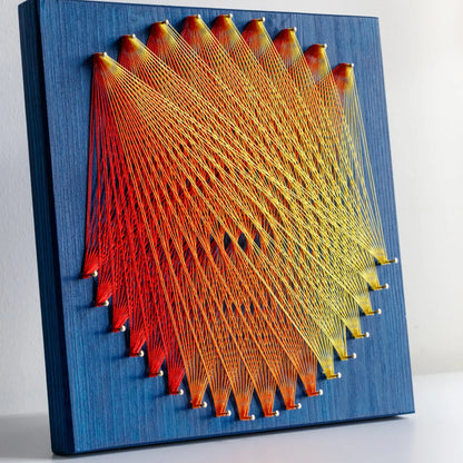 "Geometric string art with red and yellow threads on blue base, ideal craft kit for adults, featuring intricate design - red and yellow