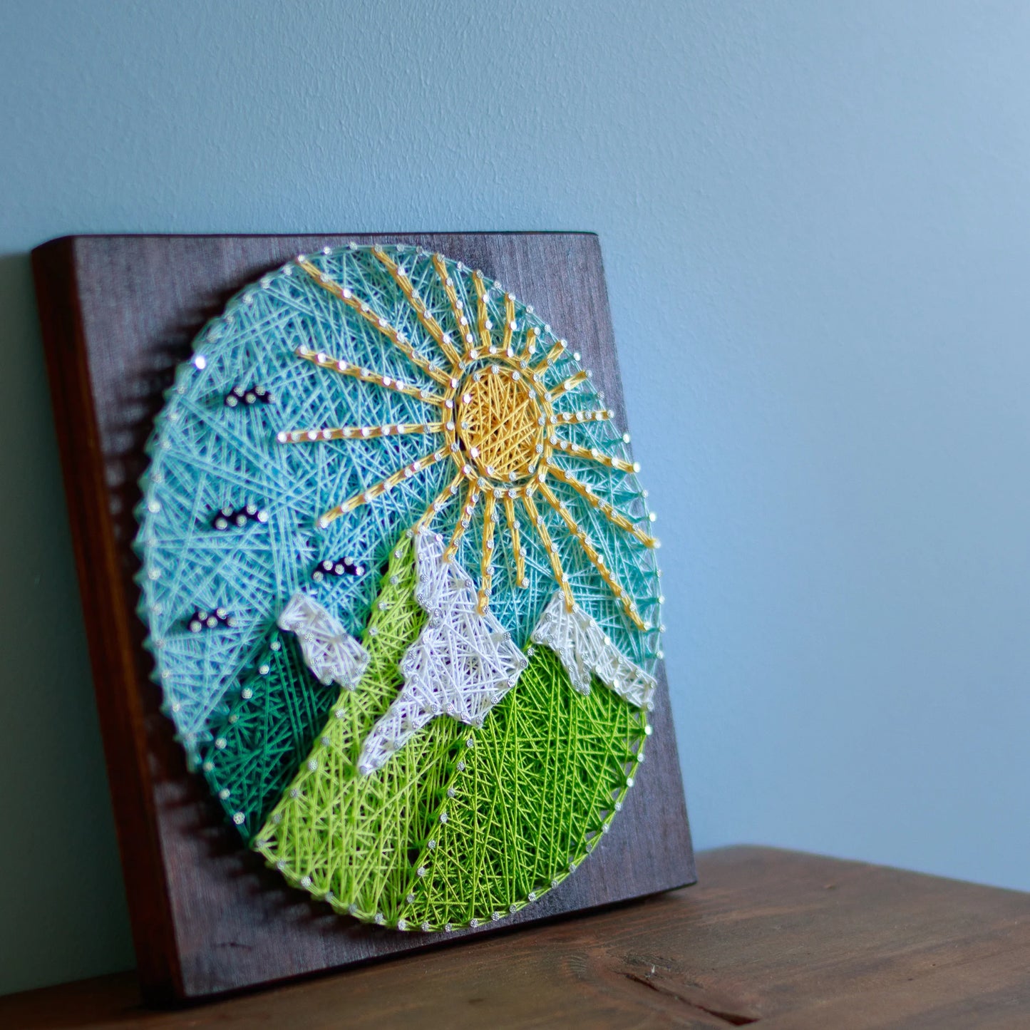 View from side - Round mountains string art pattern with a colorful sun, sky, and mountains design, available as a digital download. Perfect for beginners and nature-inspired home decor.