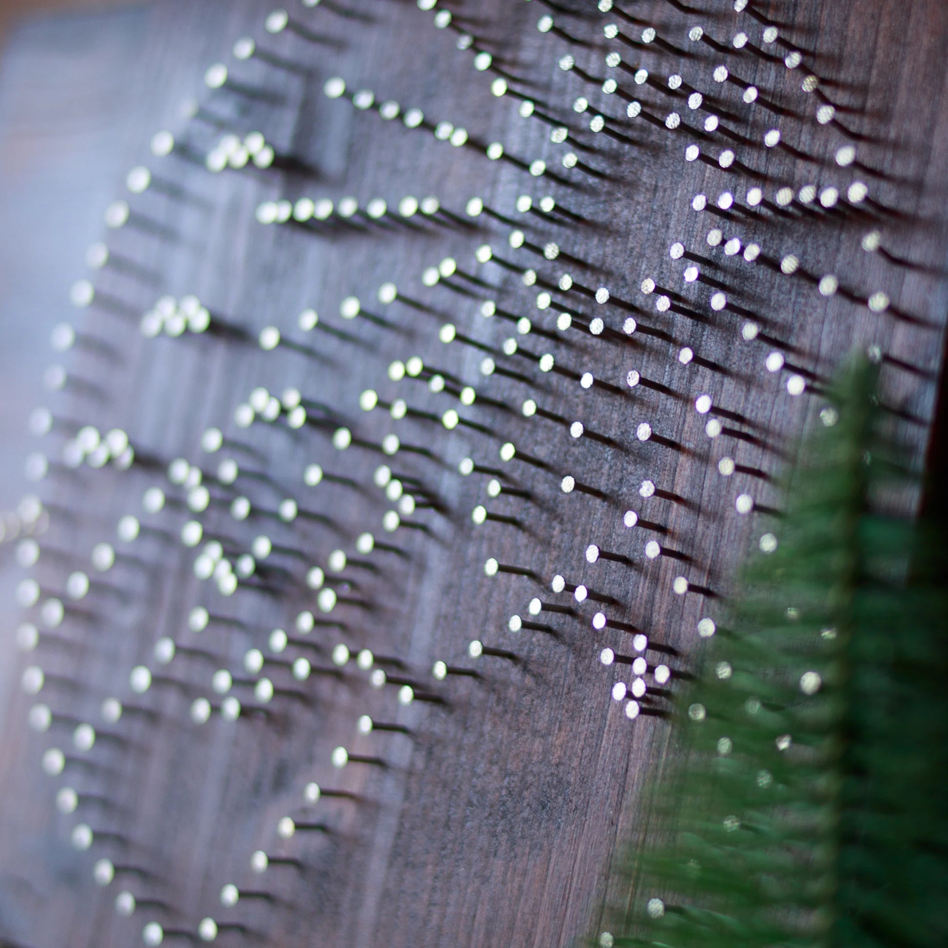 Close-up of the nail arrangement for a round mountains string art pattern, showcasing the nail placement on a dark wooden base, part of a digital download kit.