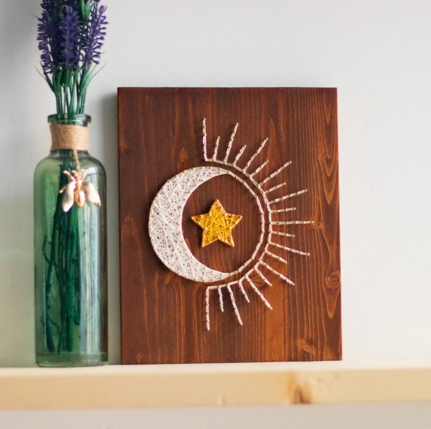 DIY string art kit featuring a crescent moon with a golden star created with threads on a wooden board by GoodStrings