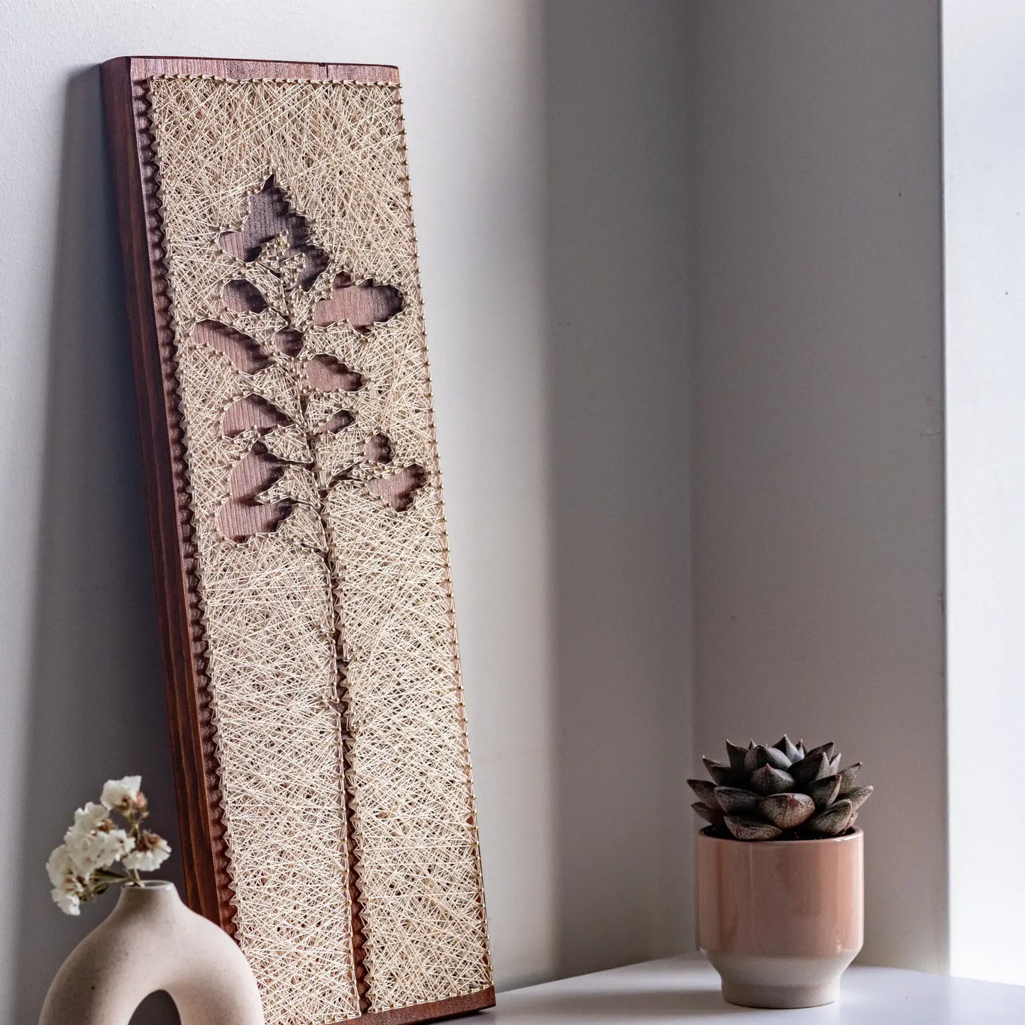 side view - Minimalist pine tree silhouette string art sign, handmade with simple lines and natural textures.