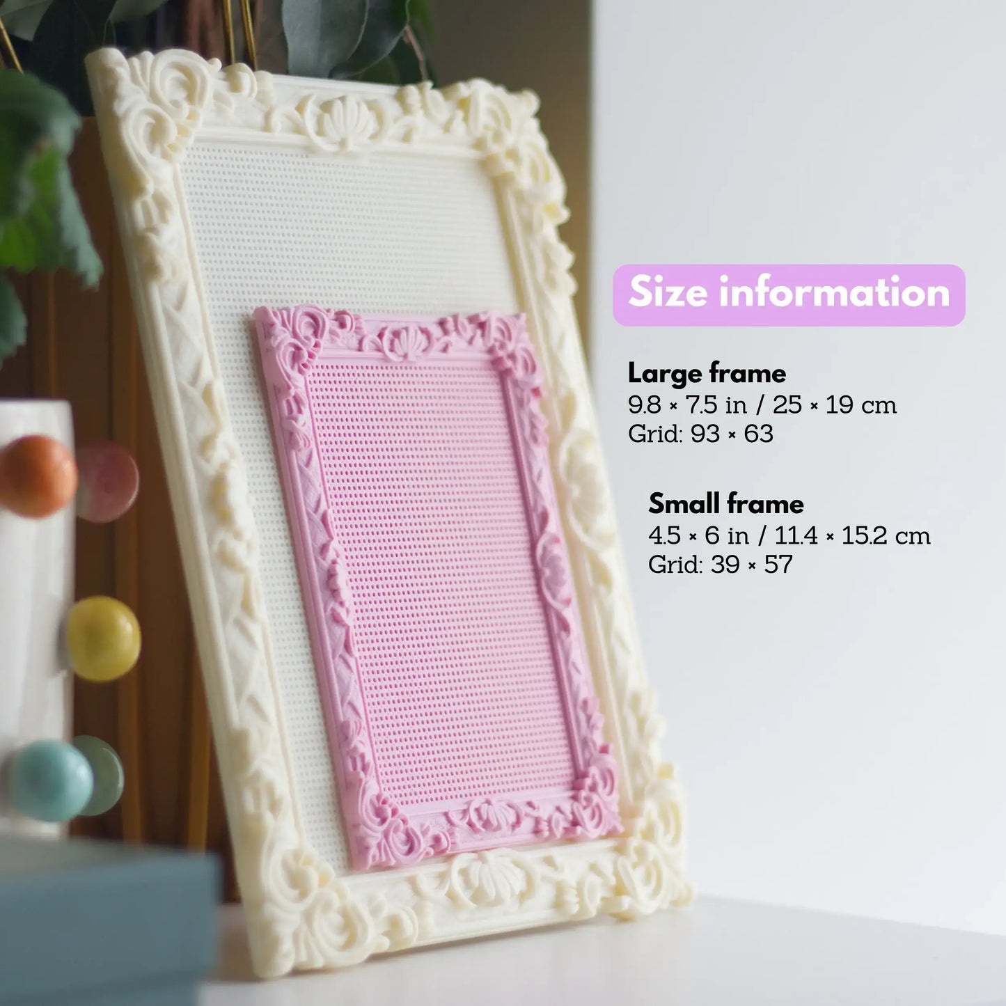 Large cream stitchable cross stitch frame with ornate floral edges and smaller pink frame layered on top, shown beside size information for both frame options.