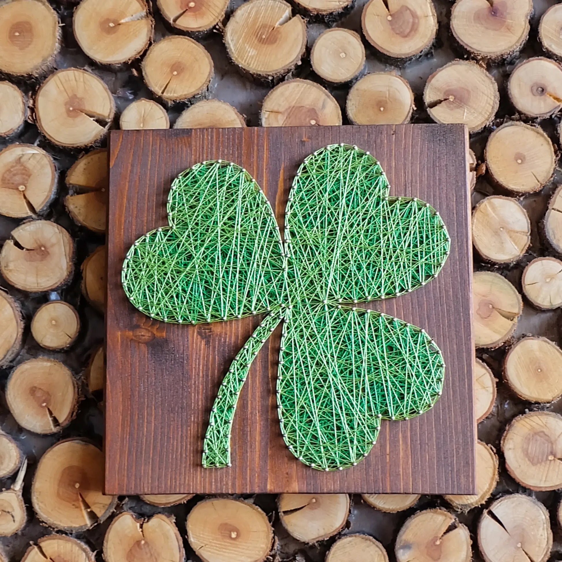 shamrock string art sign on wooden background