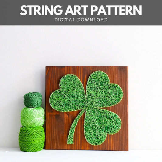 Shamrock string art pattern displayed on a wooden board, with green yarn spools beside it. Available as a digital download for creative DIY projects.