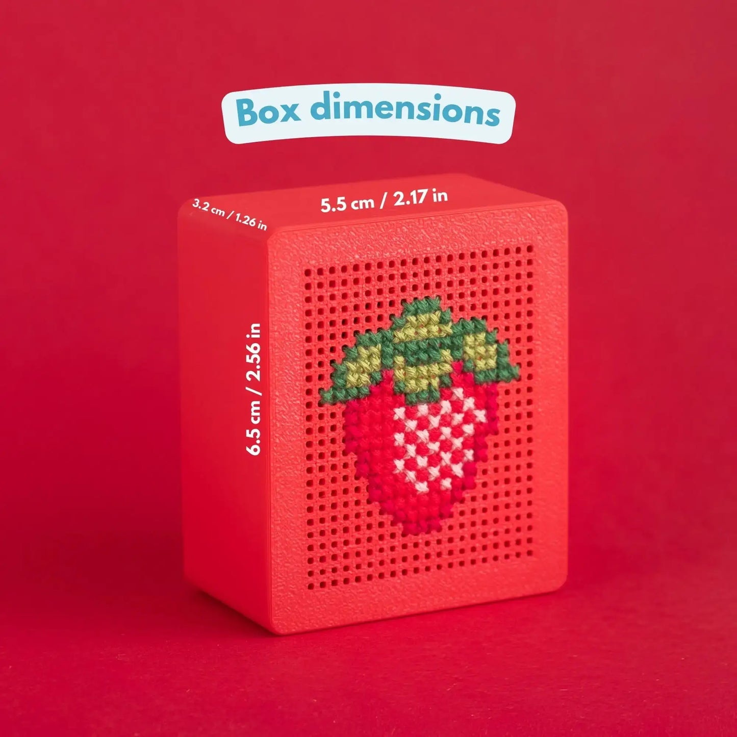 Red 3D-printed cross stitch box with a strawberry design stitched into the perforated lid, labeled with dimensions 5.5 cm / 2.17 in wide, 6.5 cm / 2.56 in tall, 3.2 cm / 1.26 in deep. Text reads Box dimensions.