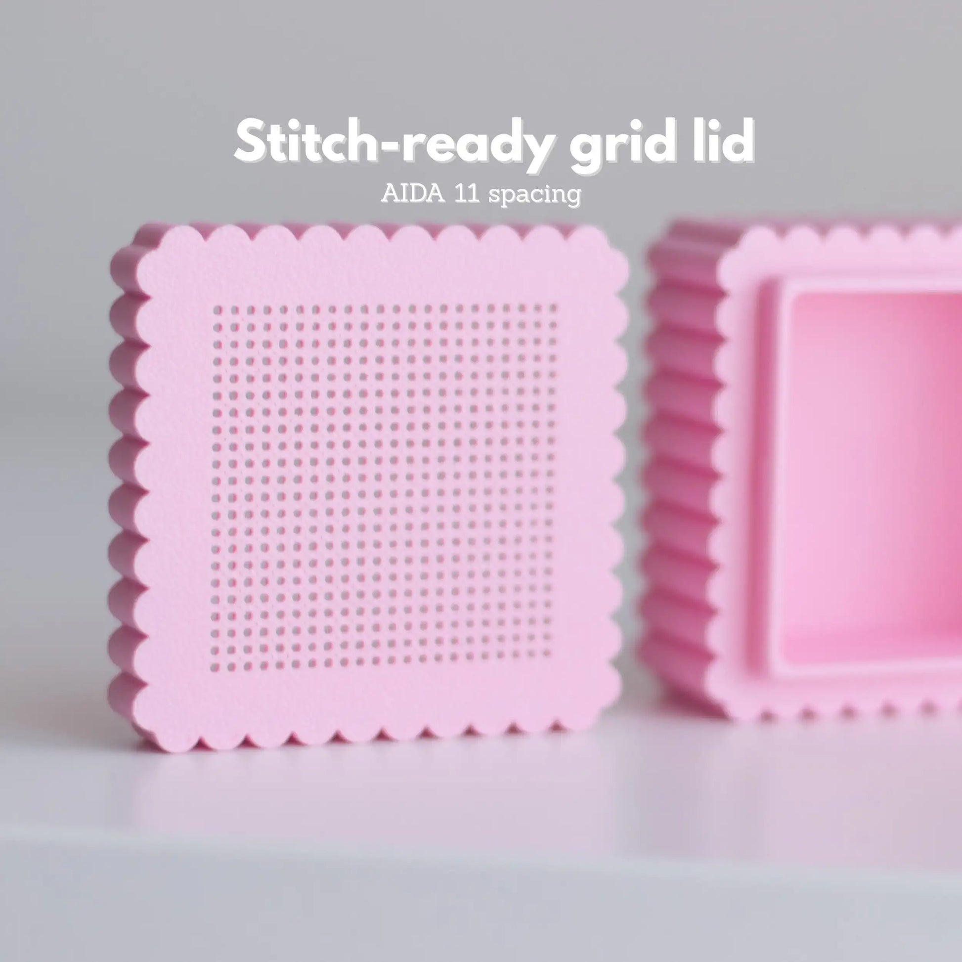 Pink mini cross stitch box lid showing perforated stitching grid with AIDA 11 spacing and removable clip inside