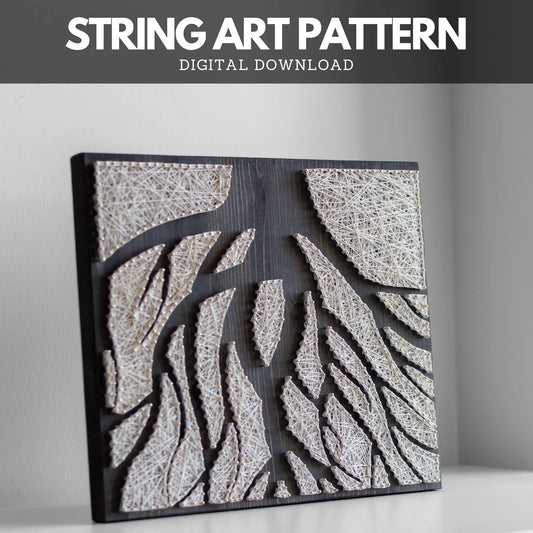 A close-up view of a tree roots string art pattern mounted on dark wood. The intricate white strings create abstract shapes resembling tree roots.