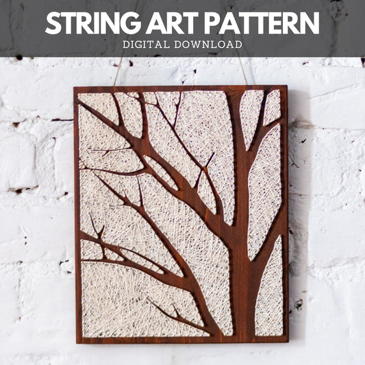 Completed tree silhouette string art, featuring ivory threads on a dark wooden background. Minimalist design ideal for wall decor.