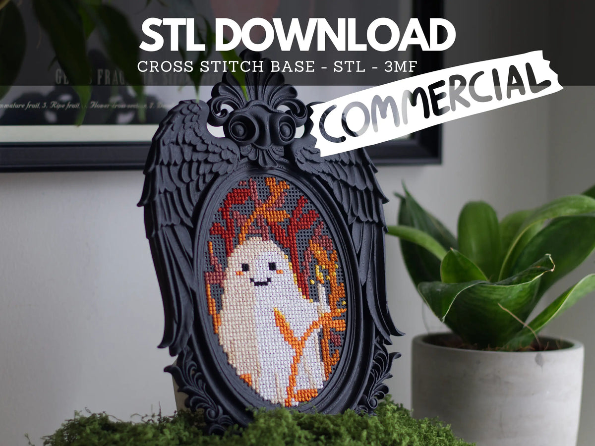 Black angel wing cross stitch frame stitched with a cute ghost, on moss beside a potted plant, labelled STL download, commercial, STL and 3MF files