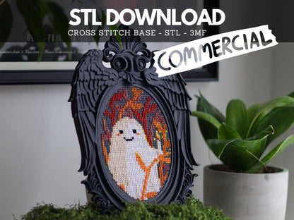 Black angel wing cross stitch frame stitched with a cute ghost, on moss beside a potted plant, labelled STL download, commercial, STL and 3MF files