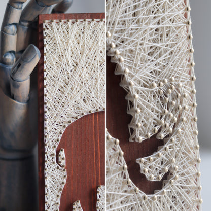 Close-up view of a woolly mammoth string art pattern showing intricate thread details and a handcrafted look. Perfect for decor projects.
